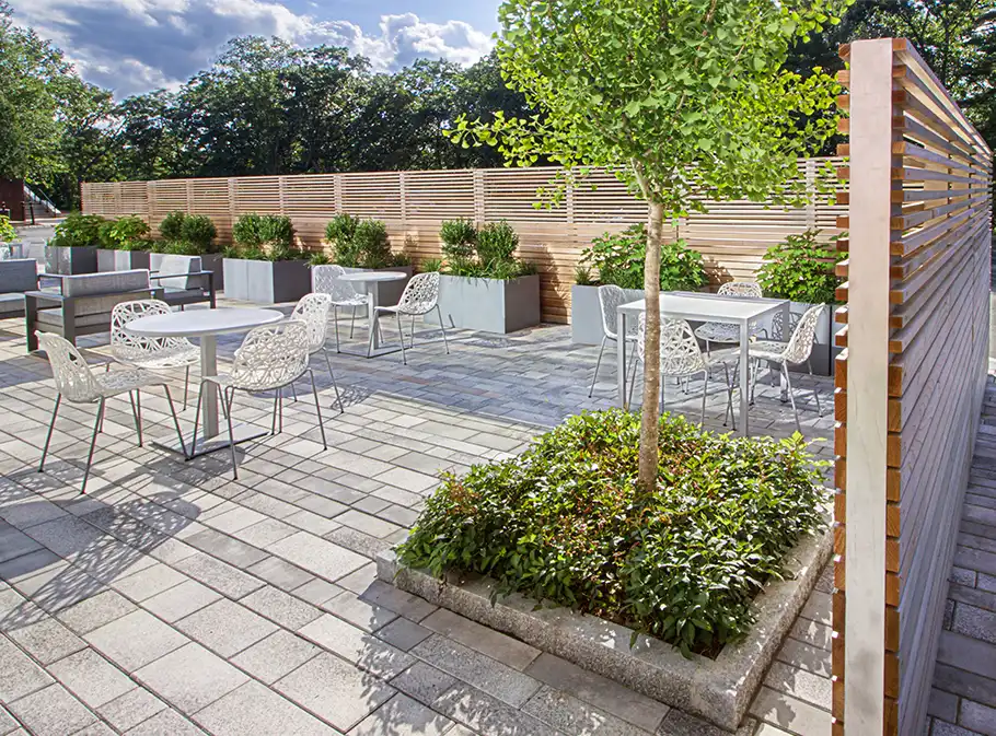 Cafe terrace with pavers and horizontal wooden fencing