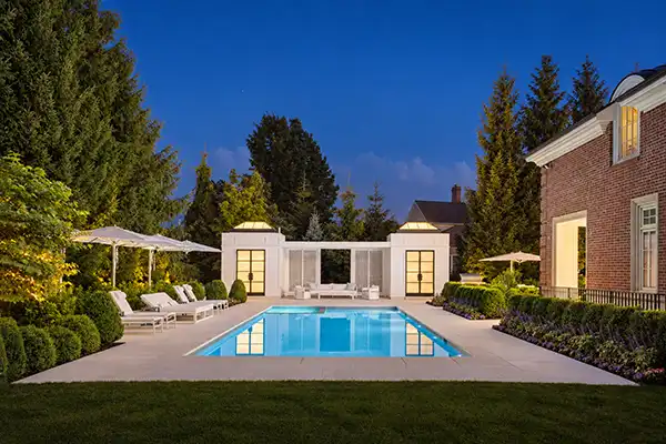 Evening view of pool side and ban