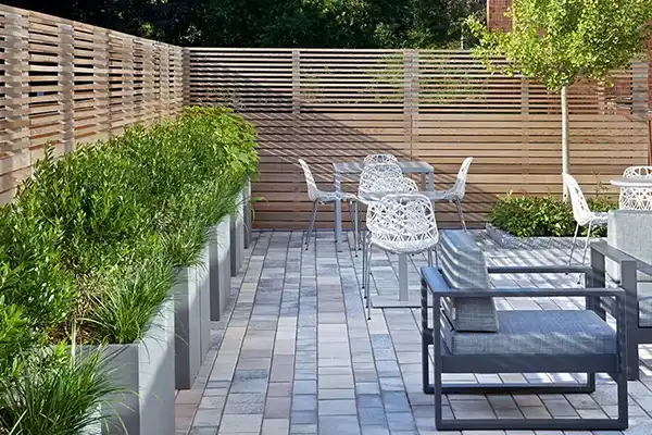 Cafe terrace with pavers and horizontal wooden fencing